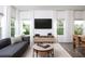 Bright living area featuring stylish furniture, large windows, and contemporary decor at 2105 Stillhaven Pl, Douglasville, GA 30135