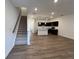 Open-concept living space leading to a modern kitchen with stainless steel appliances at 2105 Stillhaven Pl, Douglasville, GA 30135