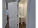 The powder room has a pedestal sink and modern lighting at 2105 Stillhaven Pl, Douglasville, GA 30135