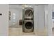 An in-unit laundry room with a sleek, modern stacked washer and dryer at 560 Dutch Valley Rd # 2313, Atlanta, GA 30324