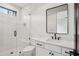 Stylish bathroom with a glass-enclosed shower, sleek vanity, black hardware, and modern fixtures at 6455 Scott Valley Rd, Sandy Springs, GA 30328