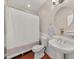 Well-lit bathroom featuring a pedestal sink, round mirror, and shower with a curtain at 756 Moreland Se Ave, Atlanta, GA 30316