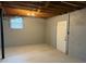 Spacious unfinished basement with painted concrete walls and door to outdoors at 184 Wana Se Cir, Mableton, GA 30126