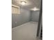 Basement with gray-painted walls, lighting fixtures, and small window for natural light at 184 Wana Se Cir, Mableton, GA 30126