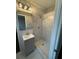 Modern bathroom boasting a gray vanity, mirror, and tiled shower with marble accents at 184 Wana Se Cir, Mableton, GA 30126