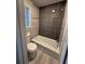 Bathroom featuring a tiled shower, tub, and window, designed for relaxation at 184 Wana Se Cir, Mableton, GA 30126