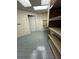 Spacious basement with tiled flooring and ample shelving storage at 217 Spalding Gates Dr, Atlanta, GA 30328