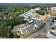 Aerial view of the community featuring townhomes, pool, streets, and surrounded by mature trees at 3316 Cranston Ln, Kennesaw, GA 30144