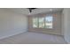 Spacious, well-lit bedroom with a large window offering neighborhood views, providing a bright and comfortable retreat at 3316 Cranston Ln, Kennesaw, GA 30144