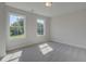 Sunlit bedroom with neutral carpet, two large windows offering exterior views, and fresh paint at 3316 Cranston Ln, Kennesaw, GA 30144