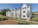 View of new townhomes featuring modern architectural details and well-maintained landscaping at 3316 Cranston Ln, Kennesaw, GA 30144