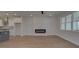 Open-concept living space boasts wood floors, a sleek fireplace, and modern decor accents at 3316 Cranston Ln, Kennesaw, GA 30144