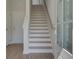 Bright foyer featuring a staircase with light wood treads, white risers and railing, and natural light from the front door at 3316 Cranston Ln, Kennesaw, GA 30144