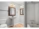 Clean bathroom features a pedestal sink, tile flooring, and a tub with a shower at 5065 Avalon Dr, Alpharetta, GA 30005