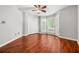This bedroom boasts hardwood floors, a ceiling fan, and a double door closet at 5065 Avalon Dr, Alpharetta, GA 30005