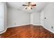 A cozy bedroom featuring hardwood floors and neutral paint at 5065 Avalon Dr, Alpharetta, GA 30005