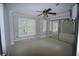 Spacious bedroom with hardwood floors, ceiling fan, and closet with mirrored doors at 5065 Avalon Dr, Alpharetta, GA 30005