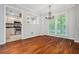 Cozy dining area with hardwood floors, a chandelier, and a view into the kitchen for easy entertaining at 5065 Avalon Dr, Alpharetta, GA 30005