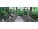 A scenic view of the Big Creek Greenway Trail with a wooden bridge and lush greenery at 5065 Avalon Dr, Alpharetta, GA 30005