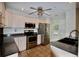 Well-equipped kitchen featuring stainless steel appliances, tiled floors, and gray counters at 5065 Avalon Dr, Alpharetta, GA 30005