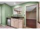 Bright kitchen sink area with stainless steel dishwasher and view to chandelier in dining room at 5065 Avalon Dr, Alpharetta, GA 30005