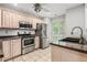 Modern kitchen with stainless steel appliances, light cabinetry, and tile flooring at 5065 Avalon Dr, Alpharetta, GA 30005