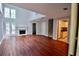 Bright living room featuring hardwood floors, fireplace, and large windows offering ample natural light at 5065 Avalon Dr, Alpharetta, GA 30005