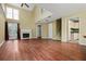 Open living room featuring hardwood floors, fireplace, french doors, and plenty of natural light at 5065 Avalon Dr, Alpharetta, GA 30005