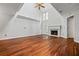 Well-lit living room featuring hardwood floors, a fireplace, and large windows that enhance the space at 5065 Avalon Dr, Alpharetta, GA 30005