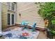 Cozy patio with outdoor seating, a colorful rug, and access to the house at 5065 Avalon Dr, Alpharetta, GA 30005