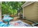 Inviting outdoor patio with bistro set and garden view at 5065 Avalon Dr, Alpharetta, GA 30005