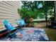 A cozy outdoor patio with bistro set and lush garden view at 5065 Avalon Dr, Alpharetta, GA 30005