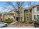 View of well-maintained townhouse, including landscaping and a parking area out front for residents and guests at 5065 Avalon Dr, Alpharetta, GA 30005