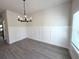 Formal dining area with wainscoting, modern chandelier, and bright windows at 5459 Blossomwood Sw Trl, Mableton, GA 30126