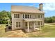 Stately home with a covered patio and lush greenery at 135 Waterlace Way, Fayetteville, GA 30215