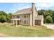 Expansive backyard view of a two-story home with plentiful windows at 135 Waterlace Way, Fayetteville, GA 30215