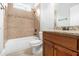Tiled bathroom features a shower-tub combo and granite vanity at 135 Waterlace Way, Fayetteville, GA 30215