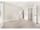 Carpeted bedroom with open doorways and double-door closet providing ample storage at 135 Waterlace Way, Fayetteville, GA 30215