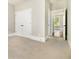 Bedroom showcasing neutral walls, double closet, and doorway to an additional room at 135 Waterlace Way, Fayetteville, GA 30215