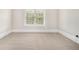 Bright bedroom featuring neutral walls, base trim, plush carpet, and a window with blinds at 135 Waterlace Way, Fayetteville, GA 30215
