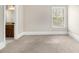 Carpeted room featuring a window and doorway to a bathroom at 135 Waterlace Way, Fayetteville, GA 30215