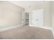 Bright, carpeted room showcasing open doorways and a double closet at 135 Waterlace Way, Fayetteville, GA 30215