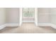 Spacious walk-in closet featuring ample shelving and natural light from a window at 135 Waterlace Way, Fayetteville, GA 30215