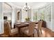 Charming dining room with decorative molding, a bay window, and a stylish chandelier at 135 Waterlace Way, Fayetteville, GA 30215