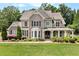 Beautiful two-story home with brick and siding exterior, manicured lawn, and inviting front porch at 135 Waterlace Way, Fayetteville, GA 30215