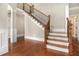 Elegant foyer with hardwood floors, staircase with iron spindles, and classic white trim at 135 Waterlace Way, Fayetteville, GA 30215