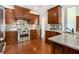 Gourmet kitchen with stainless steel appliances, custom cabinets, granite countertops, and hardwood floors at 135 Waterlace Way, Fayetteville, GA 30215