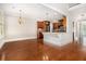 Kitchen and dining area featuring hardwood floors, wood cabinets, and granite countertops at 135 Waterlace Way, Fayetteville, GA 30215