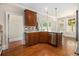 Well-appointed kitchen with stainless steel appliances, a center island, and dark wood cabinets at 135 Waterlace Way, Fayetteville, GA 30215