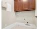 Well-lit laundry room with utility connections and wood cabinetry at 135 Waterlace Way, Fayetteville, GA 30215